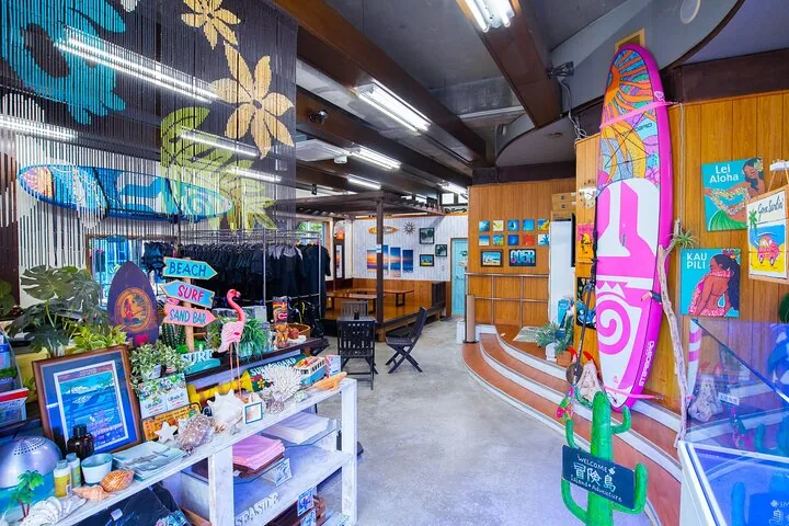Interior of a surf shop with boards, beachwear, and tropical decorations